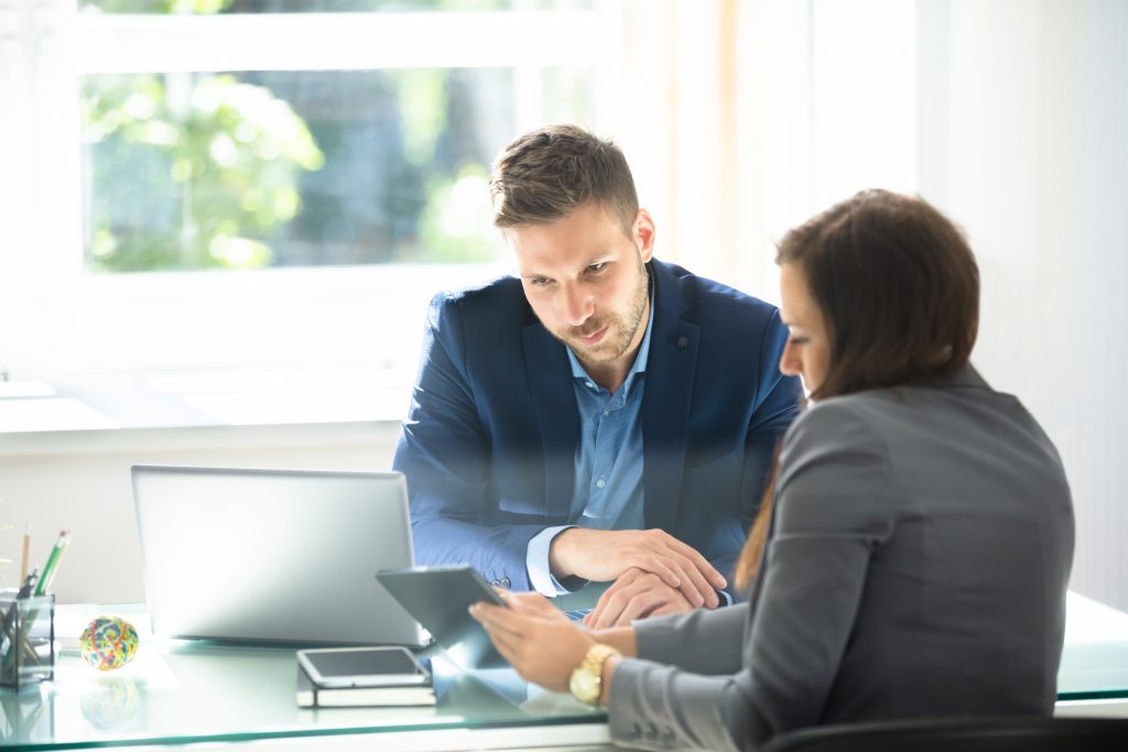 two businesspeople using digital tablet